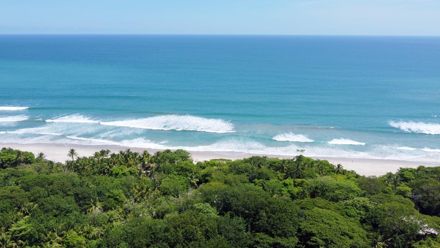 Aerial view of Santa Teresa coastline with jungle meeting the Pacific Ocean in Costa Rica